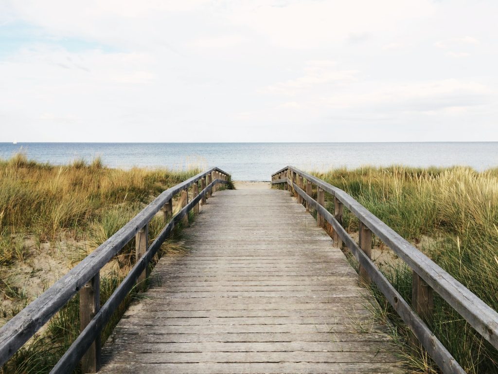 photo of gray wooden bridge